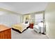 This bedroom offers large windows, a bed, and a sitting area at 23626 Genesee Village Rd, Golden, CO 80401