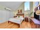 Comfortable bedroom with a queen-size bed, ample closet space, and large window allowing plenty of natural light at 23626 Genesee Village Rd, Golden, CO 80401