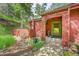 Close-up of the home's entrance featuring a green door, natural landscaping, and stone pathway at 23626 Genesee Village Rd, Golden, CO 80401