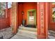 Inviting front porch with a green door frame, potted plants, and clear numbering at 23626 Genesee Village Rd, Golden, CO 80401