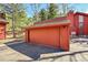 Detached red garage with ample parking space, matching the style of the house at 23626 Genesee Village Rd, Golden, CO 80401