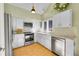 Bright kitchen features stainless steel appliances, tile backsplash, granite countertops, and wood flooring at 23626 Genesee Village Rd, Golden, CO 80401