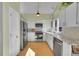 Bright kitchen features stainless steel appliances, tile backsplash, granite countertops, and wood flooring at 23626 Genesee Village Rd, Golden, CO 80401