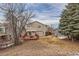 Large backyard with wood deck, patio, and spacious lawn, perfect for outdoor entertaining at 240 Corby Pl, Castle Pines, CO 80108