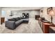 Carpeted basement with fireplace, seating, display cabinet, and adjacent bedroom area at 240 Corby Pl, Castle Pines, CO 80108