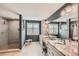 Modern bathroom featuring double vanity, tiled shower with bench seat, and plantation shutters at 240 Corby Pl, Castle Pines, CO 80108