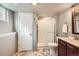 Basement bathroom with a tiled shower and granite vanity at 240 Corby Pl, Castle Pines, CO 80108