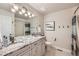 Modern bathroom with white cabinets, granite countertop, double sinks, and tiled shower at 240 Corby Pl, Castle Pines, CO 80108