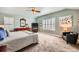 Light-filled bedroom with carpet, ceiling fan, plantation shutters, and comfortable seating at 240 Corby Pl, Castle Pines, CO 80108