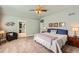 Serene bedroom with ensuite bathroom, ceiling fan, neutral carpet and decor at 240 Corby Pl, Castle Pines, CO 80108