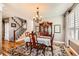 Traditional dining room with a wooden table, chandelier, hutch, and decorative rug at 240 Corby Pl, Castle Pines, CO 80108