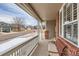 Inviting front porch featuring a comfortable bench and neighborhood views at 240 Corby Pl, Castle Pines, CO 80108