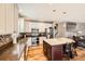 Well-lit kitchen with stainless steel appliances, a central island, and decorative tile backsplash at 240 Corby Pl, Castle Pines, CO 80108