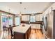 Bright kitchen with stainless steel appliances, a spacious island, and modern pendant lighting at 240 Corby Pl, Castle Pines, CO 80108