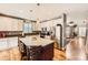 Spacious kitchen featuring a large island, stainless steel appliances, and hardwood floors at 240 Corby Pl, Castle Pines, CO 80108