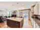 Open-concept kitchen with a large island seamlessly flowing into the living area at 240 Corby Pl, Castle Pines, CO 80108