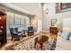 Bright living room with two-story ceilings, hardwood floors, plantation shutters, and decor at 240 Corby Pl, Castle Pines, CO 80108