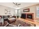 Comfortable living room featuring a brick fireplace, hardwood floors, and ample seating at 240 Corby Pl, Castle Pines, CO 80108