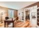 Office area with hardwood floors, window shutters, desk and glass paneled french doors at 240 Corby Pl, Castle Pines, CO 80108