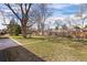 Large backyard featuring a mature tree with a tire swing, offering a serene and inviting outdoor space at 991 E Applewood Ave, Centennial, CO 80121