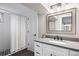 Bathroom featuring updated vanity with countertop and sink, and a tiled shower at 991 E Applewood Ave, Centennial, CO 80121