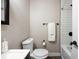 Cozy bathroom featuring a dark vanity, toilet, and mirror with a white towel on the rack at 991 E Applewood Ave, Centennial, CO 80121