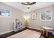 Bright bedroom with dark hardwood floors, neutral walls, and natural light from two windows at 991 E Applewood Ave, Centennial, CO 80121