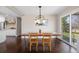 A dining room featuring a wooden table with decor, stylish chairs, and a sliding glass door with outdoor view at 991 E Applewood Ave, Centennial, CO 80121