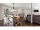 Open dining area with a modern table and bench seating, sliding glass door with natural light, and stylish accents at 991 E Applewood Ave, Centennial, CO 80121