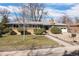 Inviting single-story home with a well-kept lawn, mature trees, and a two-car garage, creating curb appeal at 991 E Applewood Ave, Centennial, CO 80121