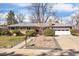 Charming single-story home with a well-manicured lawn, decorative rock garden, and a two-car garage at 991 E Applewood Ave, Centennial, CO 80121