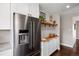 Kitchen with stainless steel refrigerator, butcher block countertops, and stylish open shelving at 991 E Applewood Ave, Centennial, CO 80121