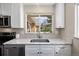 Bright kitchen with stainless steel appliances, sleek countertops, and a large window over the sink at 991 E Applewood Ave, Centennial, CO 80121