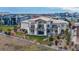 Aerial view showcases a large luxury home with manicured grounds and beautiful mountain views at 703 Emberglow Ln, Highlands Ranch, CO 80126