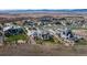 Aerial view of luxury home in a community with beautiful landscaping and mountain backdrop at 703 Emberglow Ln, Highlands Ranch, CO 80126