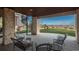Covered patio area with outdoor seating and a spiral staircase with open views of the landscape at 703 Emberglow Ln, Highlands Ranch, CO 80126