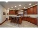 Well-designed bar area with a counter, seating, ample cabinetry and display shelving at 703 Emberglow Ln, Highlands Ranch, CO 80126