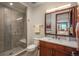 Stylish bathroom features a glass shower with decorative tile accents and a wood vanity at 703 Emberglow Ln, Highlands Ranch, CO 80126