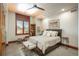 Comfortable bedroom featuring a cozy bench, accent chair and a window with wooden shutters at 703 Emberglow Ln, Highlands Ranch, CO 80126