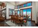 The dining room has beautiful windows with views of the city below and a stylish light fixture at 703 Emberglow Ln, Highlands Ranch, CO 80126