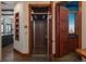 Interior home elevator with wood accents and a view of the kitchen at 703 Emberglow Ln, Highlands Ranch, CO 80126