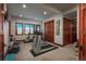 Well-equipped exercise room with modern equipment, natural light, and a mirrored wall at 703 Emberglow Ln, Highlands Ranch, CO 80126