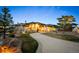 Stunning single Gathering home with a curved driveway and well manicured front yard landscaping at 703 Emberglow Ln, Highlands Ranch, CO 80126