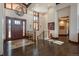 Elegant foyer with hardwood floors, a grand chandelier, and an abundance of natural light at 703 Emberglow Ln, Highlands Ranch, CO 80126