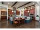 Modern kitchen with dark wood cabinetry, a built in seating area, and stainless steel appliances at 703 Emberglow Ln, Highlands Ranch, CO 80126