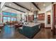 Open-concept kitchen with a large island, dark wood cabinets, and hardwood floors that connect to the dining area at 703 Emberglow Ln, Highlands Ranch, CO 80126