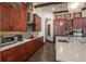 Updated kitchen featuring custom wood cabinets, stainless steel appliances, and a sleek backsplash at 703 Emberglow Ln, Highlands Ranch, CO 80126