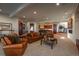 Spacious living room with comfortable seating, fireplace, and open access to the bar at 703 Emberglow Ln, Highlands Ranch, CO 80126
