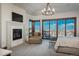This beautiful main bedroom has plenty of windows, a fireplace, and great views at 703 Emberglow Ln, Highlands Ranch, CO 80126