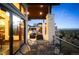 Beautiful covered patio with ample seating and gorgeous views of the surrounding landscape at 703 Emberglow Ln, Highlands Ranch, CO 80126
